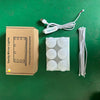 A box containing a dimmable LED vanity mirror, its power cord, and several round light bulbs on a green surface.