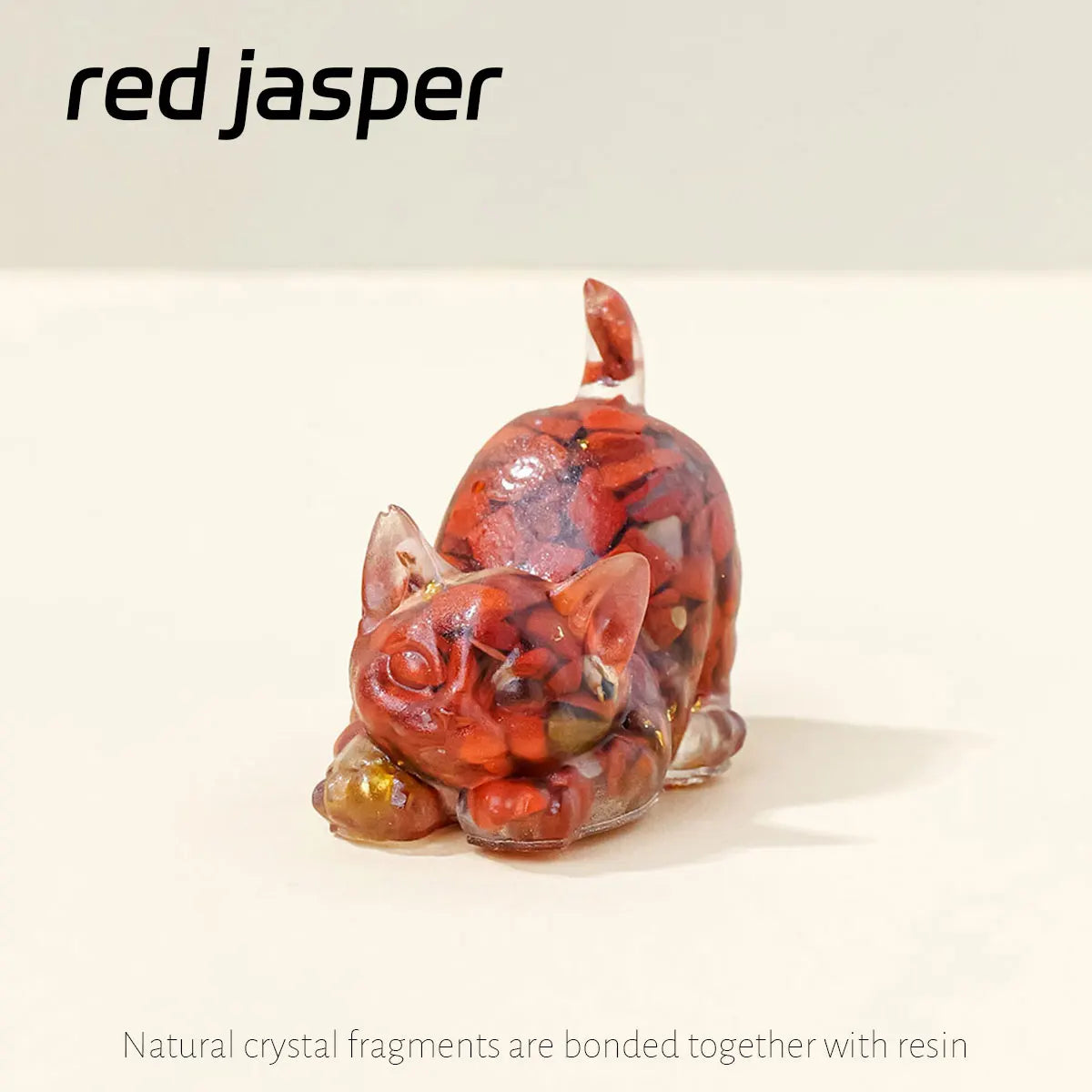 A reddish-orange crystal fragment statue of a crouching cat made with resin.