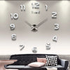 A modern 3D acrylic wall clock with DIY sticker numbers displaying the time.