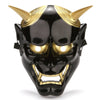 A full face Japanese Hannya demon mask with black skin, golden horns, and an open mouth.