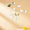 White acrylic heart wall stickers spelling LOVE with a mirror finish and small heart accents