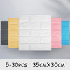 A collection of self-adhesive 3D foam wall panels in various colors including black, yellow, white, and pink, displayed side 