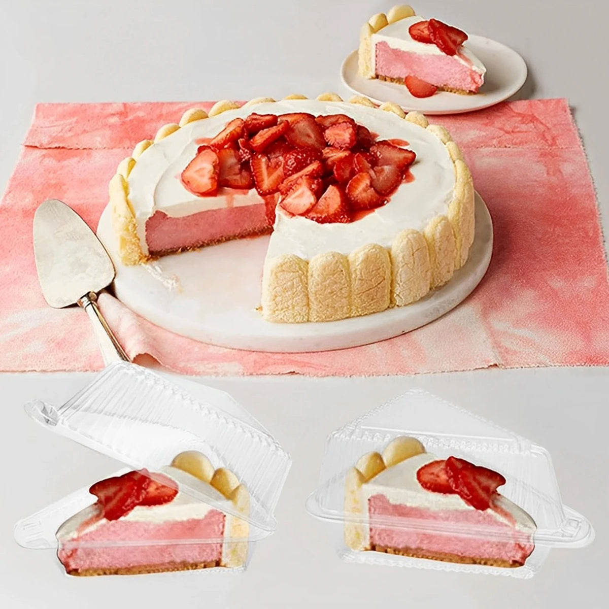 A whole strawberry cake is displayed on a plate, with individual slices packaged in clear triangle containers.