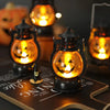 A DIY Halloween pumpkin lantern with an orange glow and LED projection effect sitting on a wooden surface.