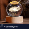 A glass crystal ball with a glowing galaxy design rests on a natural wooden base.