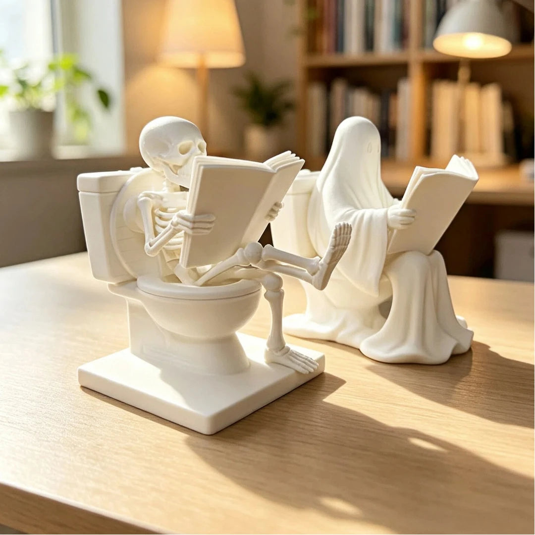 A white statue depicting a skeleton ghost reading a book next to a figure in flowing robes.
