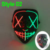 A black mask with glowing neon green and red lines forming an 'X' pattern, used for Halloween cosplay.