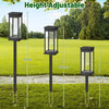 Three adjustable height black outdoor pathway lights with glass globes shown in a grassy yard.