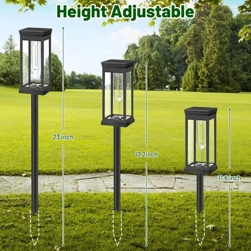 Three adjustable height black outdoor pathway lights with glass globes shown in a grassy yard.
