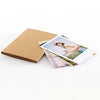 A brown accordion folding photo album with several photos displayed.