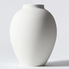 A large matte black decorative vase with a smooth, rounded shape is shown against a light gray background.
