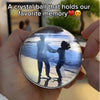 A crystal ball showing a silhouette of two people standing on the beach at sunset.