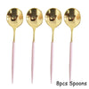 Eight gold spoons with pink handles for a party tableware set