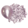 A single metallic lilac latex balloon next to a pile of crumpled silver foil balloons.