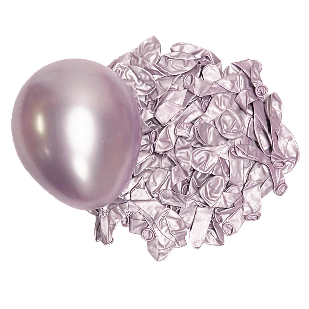 A single metallic lilac latex balloon next to a pile of crumpled silver foil balloons.