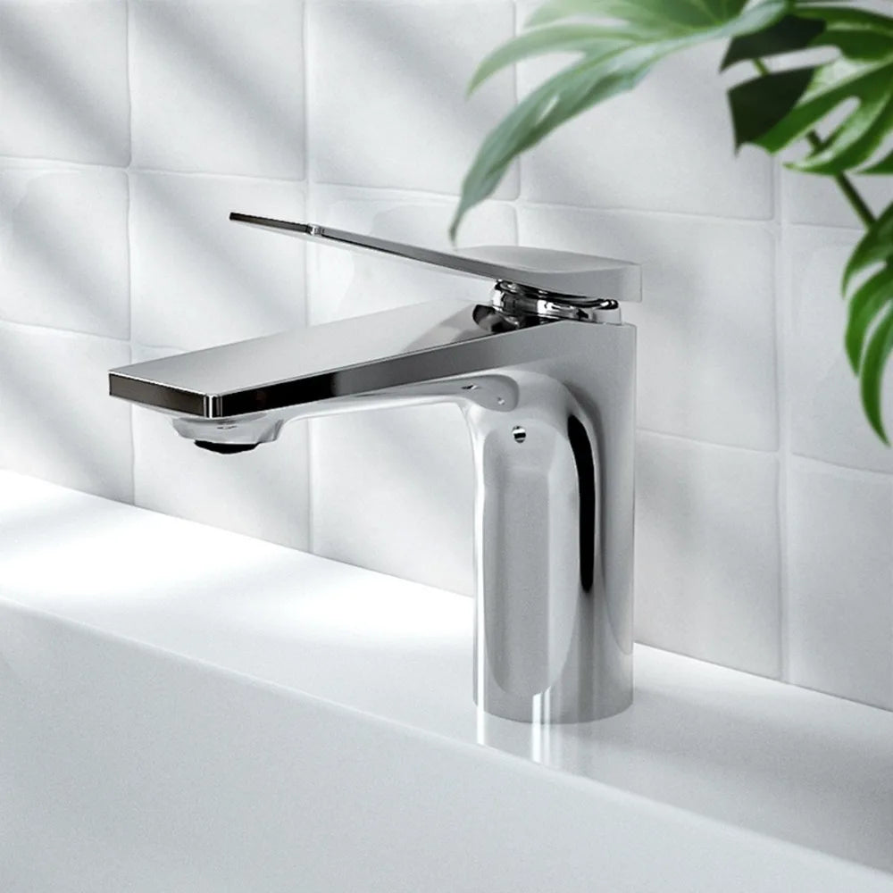 A modern chrome faucet mounted on a white countertop against a tiled backsplash.