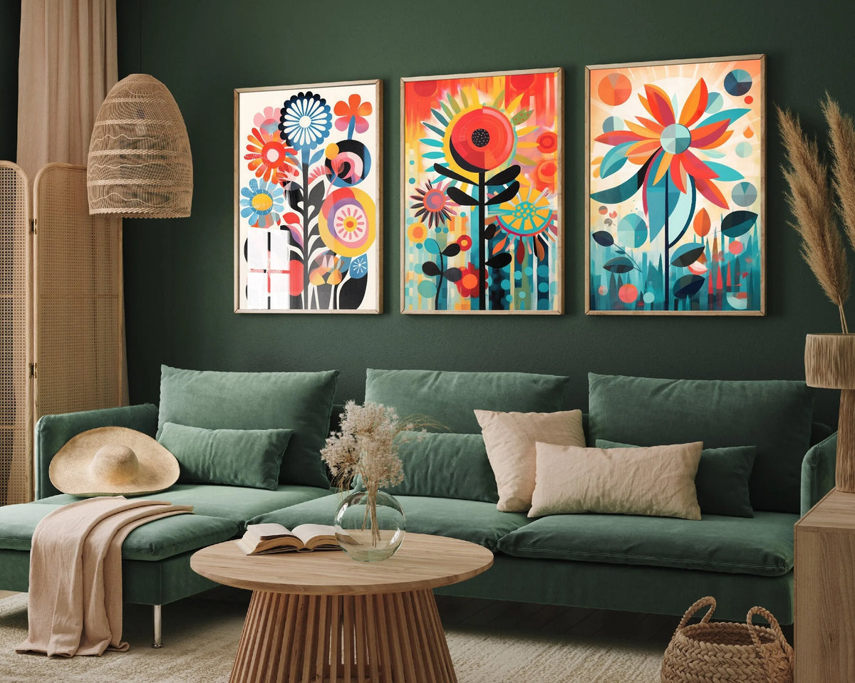 Three canvas prints featuring colorful retro wildflowers and landscape designs displayed on a dark green wall.