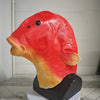 A realistic red and yellow fish head latex mask displayed on a black stand.