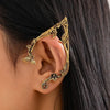 Gold elf flower leaf clip earrings worn on a woman's ear.