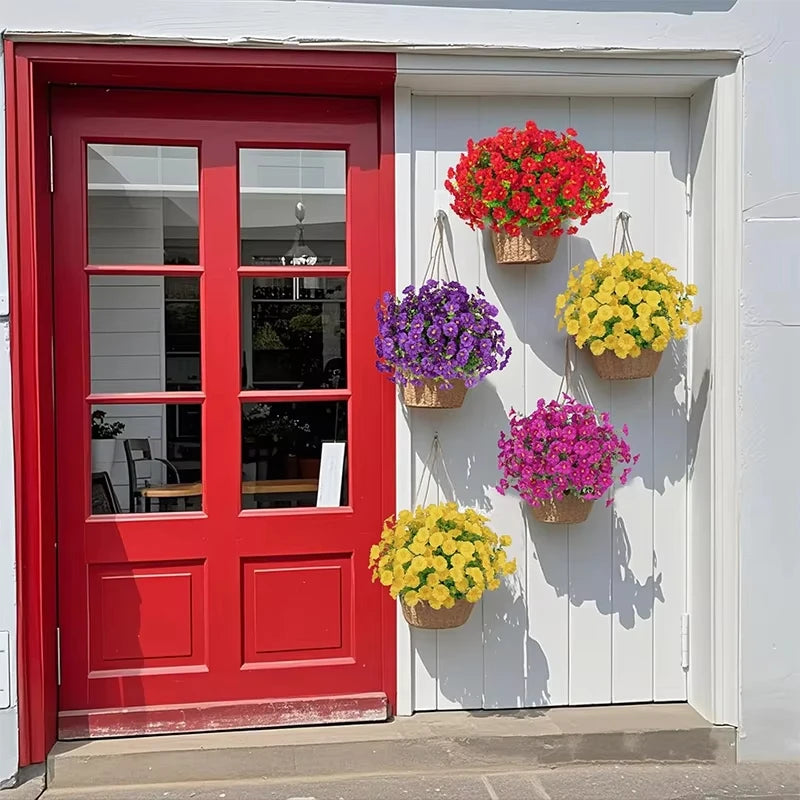 A bright red door and white door featuring hanging potted flowers in shades of red, purple, yellow, and pink.