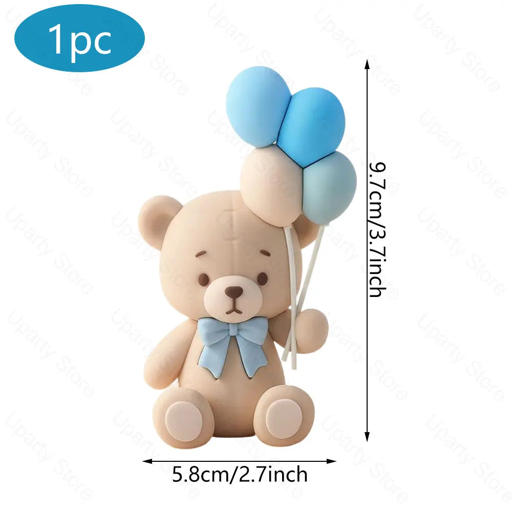 Cute light brown bear cake topper with blue foam balloons and a light blue bow