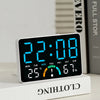 A digital alarm clock displaying 22:08 with temperature and humidity readings on a white base.