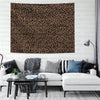 A close-up of a leopard print decorative wall tapestry hanging on a light-colored wall.