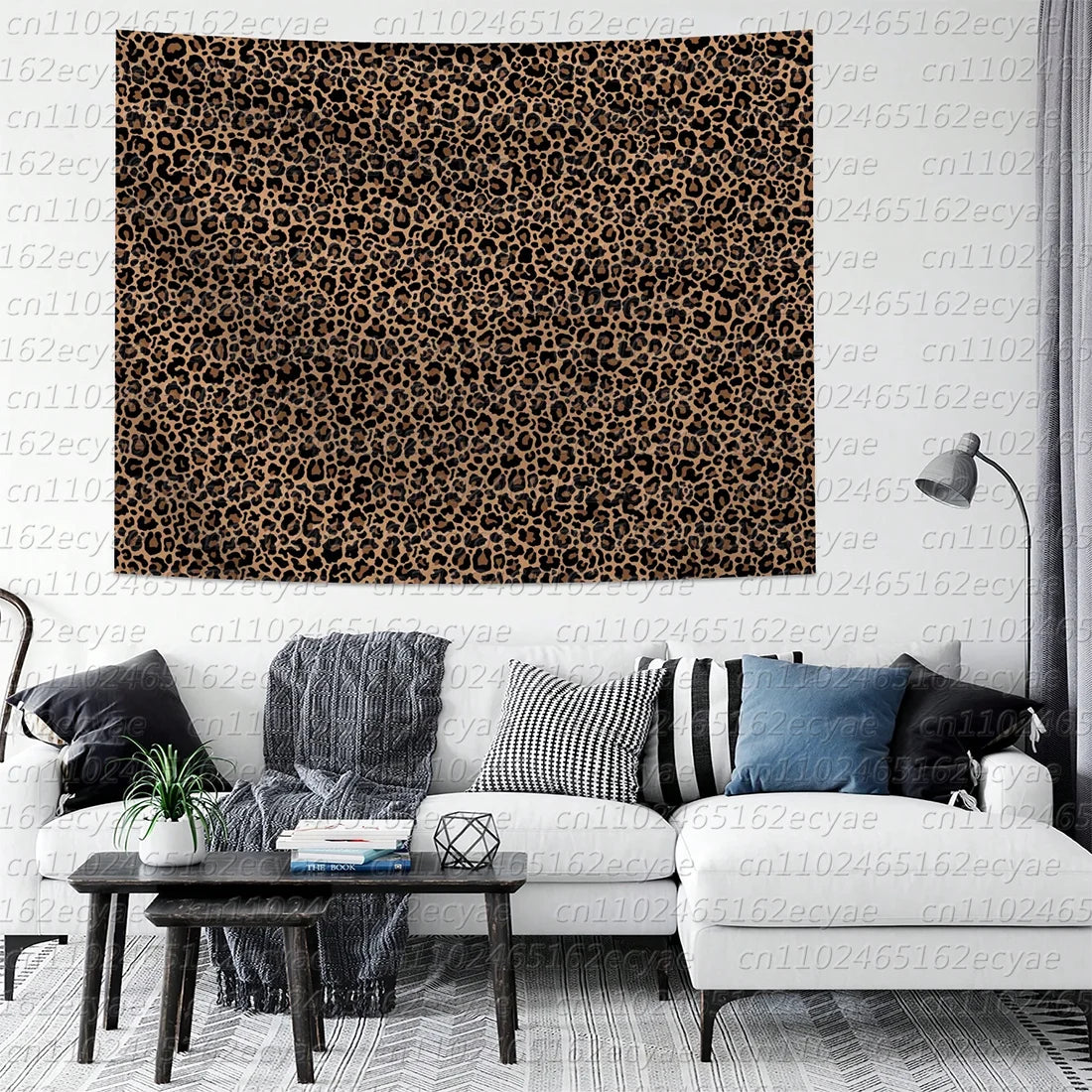 A close-up of a leopard print decorative wall tapestry hanging on a light-colored wall.