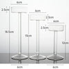 Three clear crystal glass candle holders of varying heights and diameters shown against a white background.
