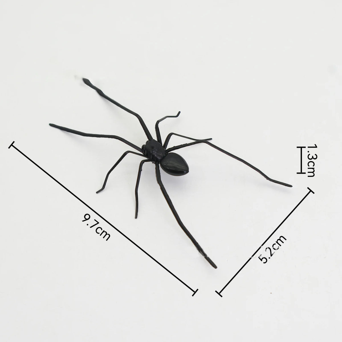 A black realistic spider magnet with outstretched legs shown against a white background.