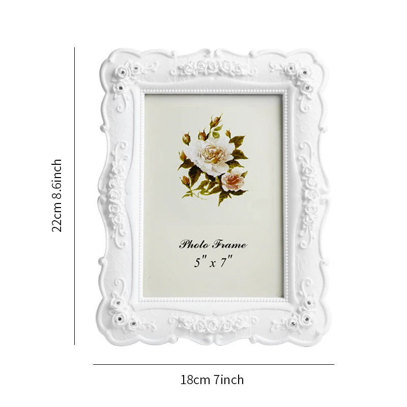 White ornate frame with a floral design and a photo insert