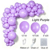 A collection of light purple latex balloons, ribbons, chains, and glue for party decor.