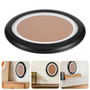 A round, matte terracotta-colored cosmetic compact with a black rim and lid.