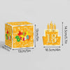 A yellow birthday gift box with a number 18 on top and lit candles.