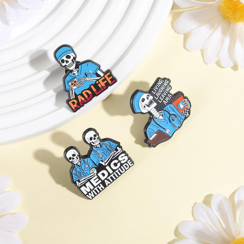A set of enamel pins featuring cartoon skulls and text like RAD LIFE and MEDICS WITH ATTITUDE on a light background.