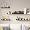 A display of floating metal wall shelves in black and gold holding various decorative items.