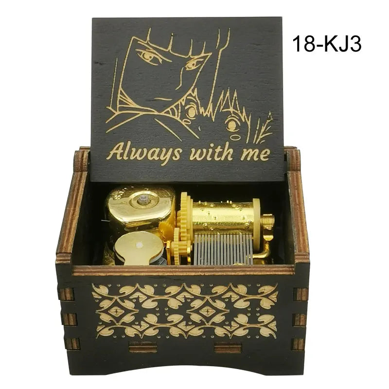 A wooden box containing a gold-colored music box with an anime character design on the lid.
