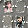 A set of clear acrylic photocard holders featuring an idol and angel wings, displayed against a dark gray background.