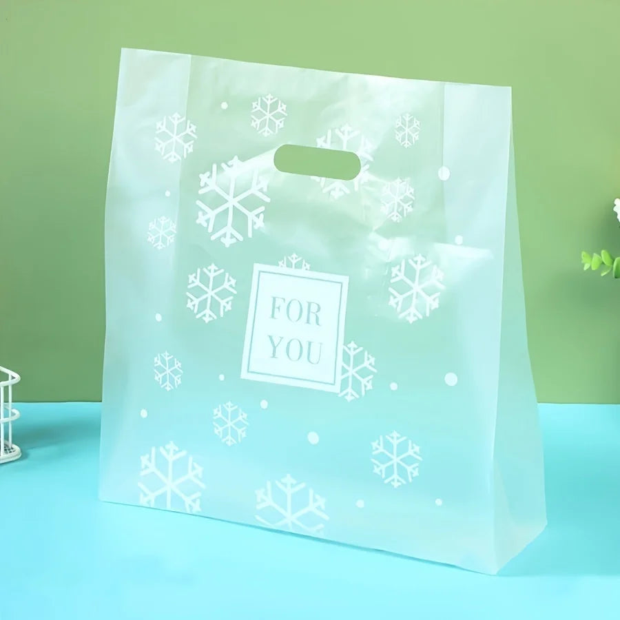 A clear plastic gift bag with a white snowflake pattern and the text For You