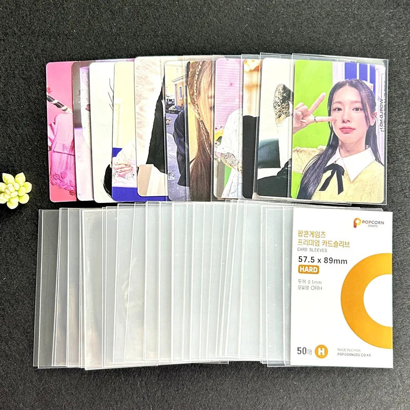 A pack of 50 crystal clear protective card sleeves featuring various designs and a woman's portrait.