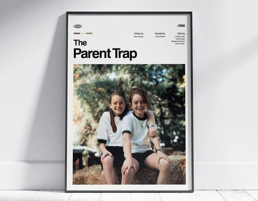 A framed poster titled The Parent Trap featuring two young girls sitting outdoors.