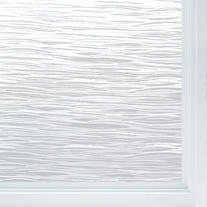 Close-up of frosted glass window privacy film with a vertical wood grain texture and white frame.