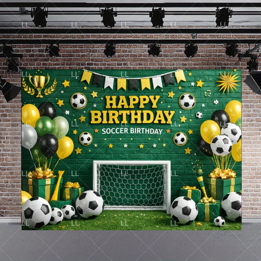 A green soccer field backdrop for a birthday celebration featuring a goal, soccer balls, and festive decorations.