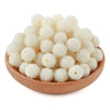 A pile of small, white textured resin beads with silver glitter for jewelry making