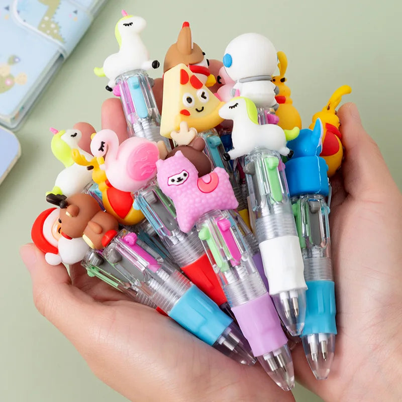 A hand holds a set of five cute cartoon mini ballpoint pens featuring various animal characters and bright colors.
