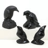 Hand-carved black obsidian raven figurines in various poses and sizes