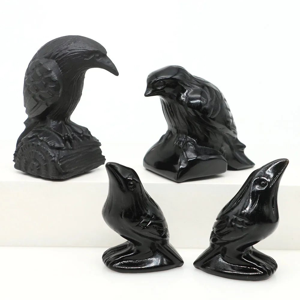 Hand-carved black obsidian raven figurines in various poses and sizes