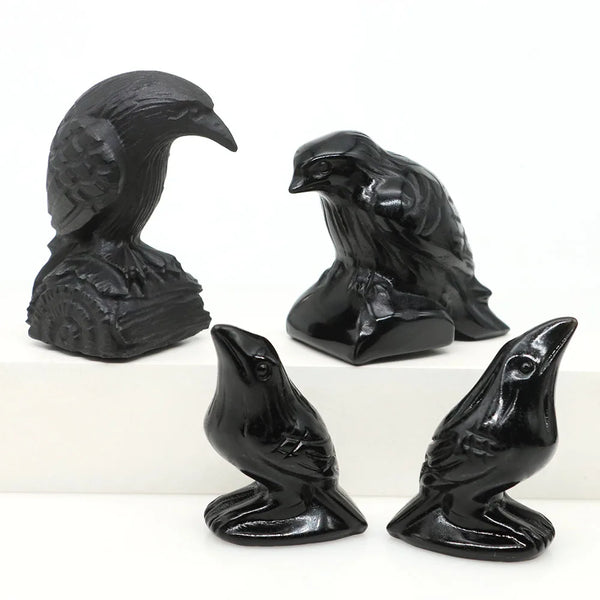 Hand-carved black obsidian raven figurines in various poses and sizes