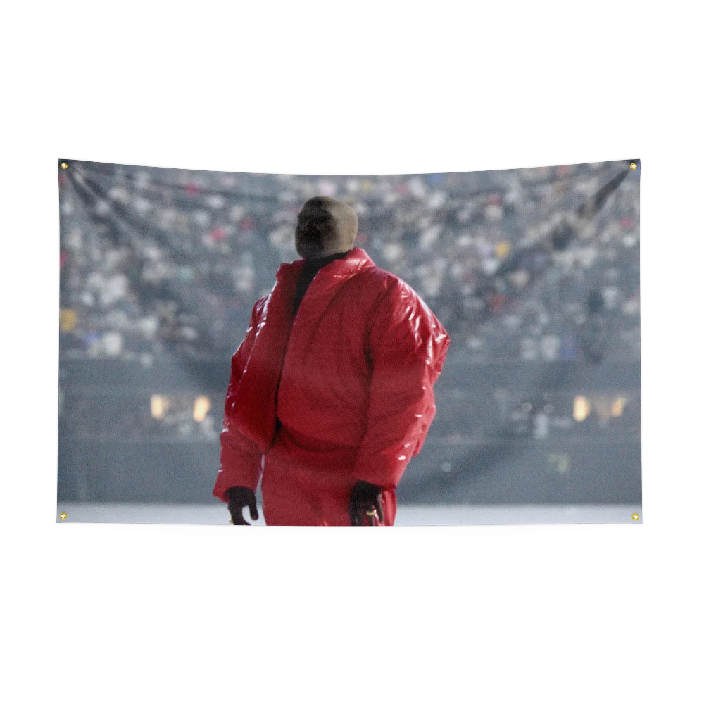 A man wearing a red jacket stands in a stadium setting.