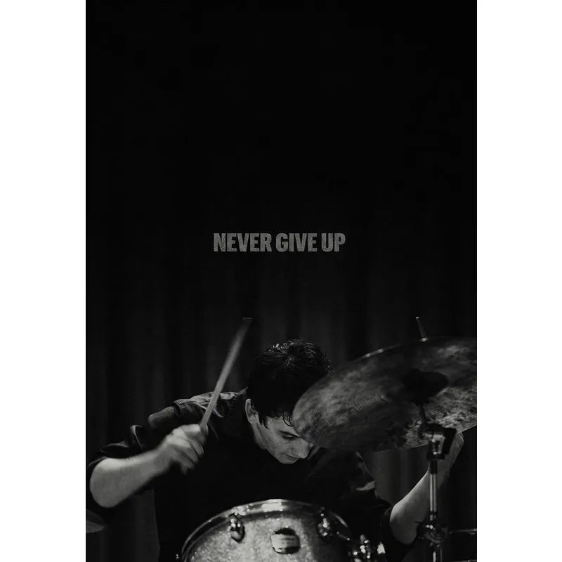 A black and white photo of a person playing a drum, likely depicting an athlete's mindset.